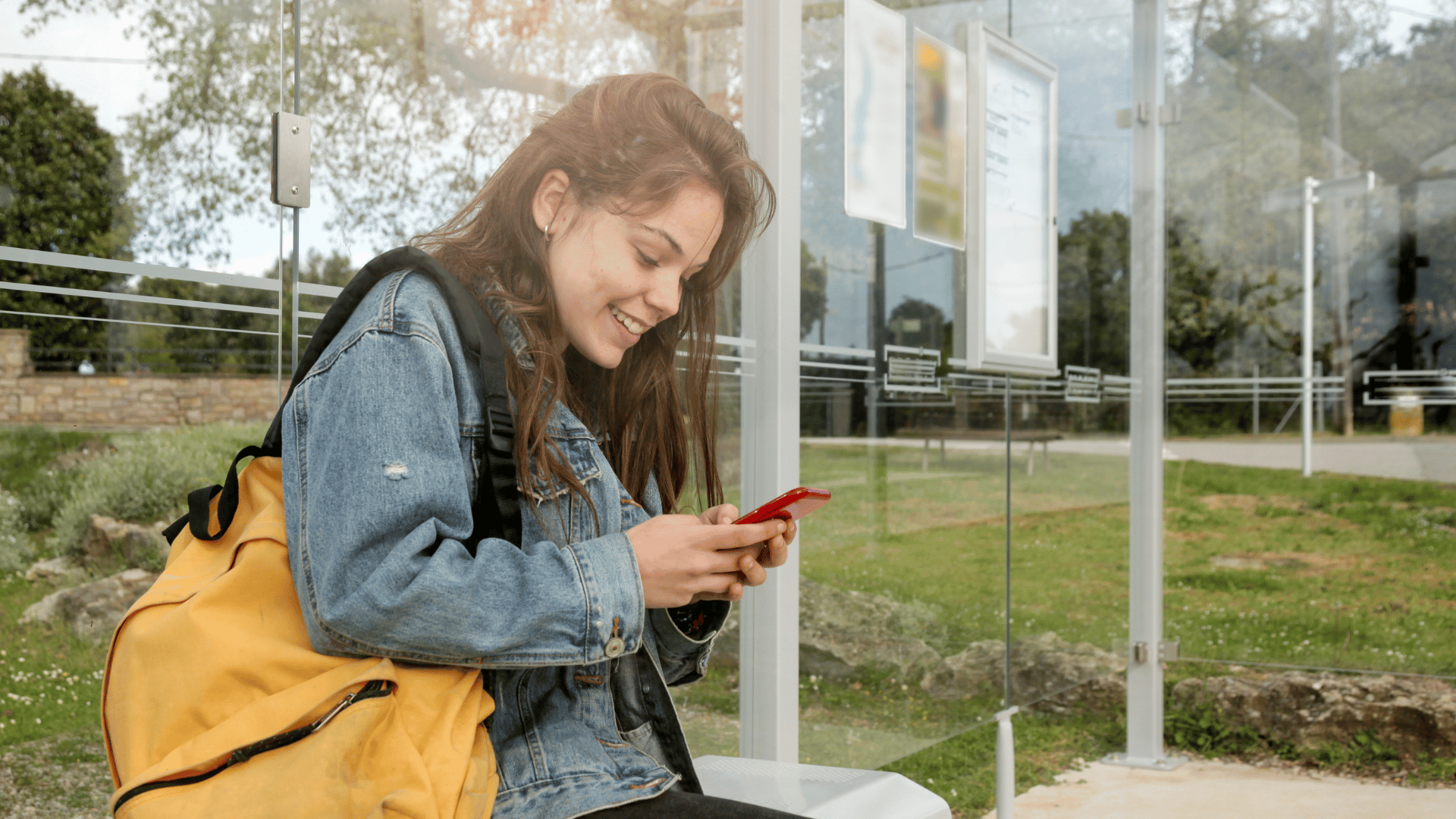 student at bus stop